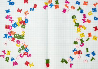  white sheets in a box and small multi-colored wooden letters