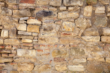 Old cracked stone masonry wall texture