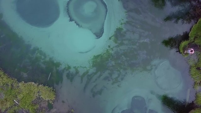 Incredibly colorful geyser lake in the outback of Altai, Aktash, Russia. Aerial view top