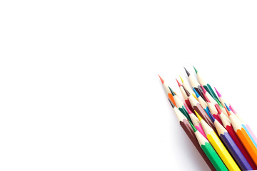 Fototapeta premium Set of school color pencils isolated on white background. Top view, flat lay composition, frame, layout. Copy space for text or design.