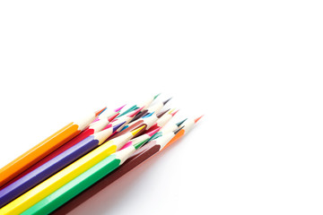 Fototapeta premium Set of school color pencils isolated on white background. Top view, flat lay composition, frame, layout. Copy space for text or design.