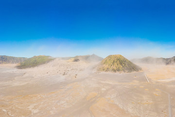 Panoramic Aerial shot of the Bromo volcano and Batok volcano at the Bromo Tengger Semeru National Park on Java Island, Indonesia. One of the most famous volcanic objects in the world. Travel to