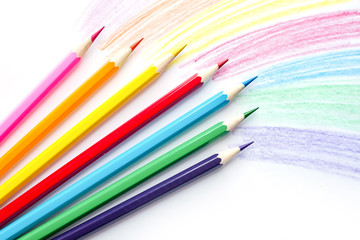 Color pencils with rainbow drawing isolated on white background. Top view.
