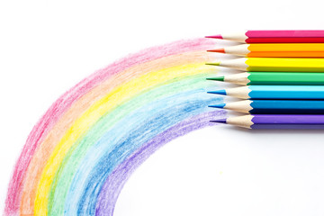 Color pencils with rainbow drawing isolated on white background. Top view.