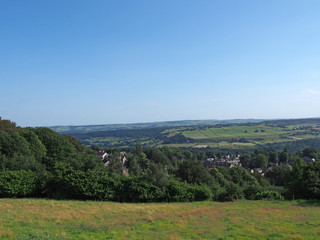 Fototapeta na wymiar a panoramic view west yorkshire countryside with the village of warley surrounded by woodland and farmland with pennine hills in the distance