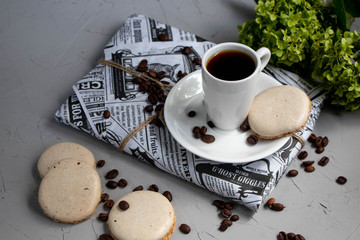 I wrapped a gift in wrapping paper. A cup of coffee will help you relax. Next to it is a delicious bisse. All on a light background. 