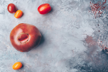 Heirloom and cherry tomatos on the grey drop