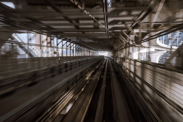motion-blurred view from a moving train running in tunnel