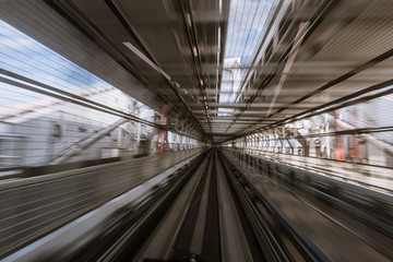 Obraz premium motion-blurred view from a moving train running in tunnel