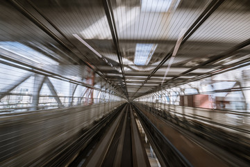 motion-blurred view from a moving train running in tunnel