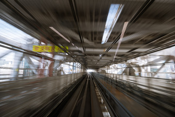 motion-blurred view from a moving train running in tunnel