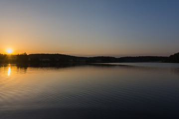 Fototapeta na wymiar sunrise over the lake on a summer day