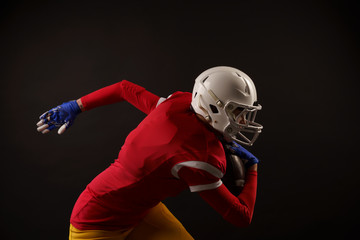 Photo of sporty woman running to right with rugby ball in helmet