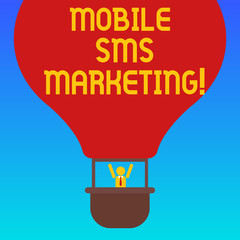 Fototapeta premium Handwriting text Mobile Sms Marketing. Concept meaning campaign that interact with your customers via text Hu analysis Dummy Arms Raising inside Gondola Riding Blank Color Air Balloon