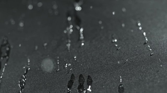 Super Slow Motion Shot of Water Droplets Splashing on Waterproof Cloth at 1000fps.
