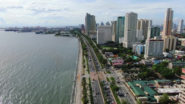 View of the wide sea and the seafront cities of Manila by the Roxas Boulevard road.