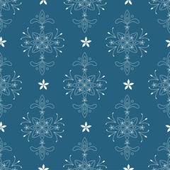 Wallpaper in the style of baroque with floral elements on the blue background. A seamless vector pattern. For scrapbooking, cover, background, textile, wallpaper use.