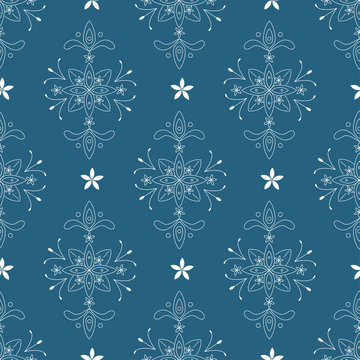 Wallpaper in the style of baroque with floral elements on the blue background. A seamless vector pattern. For scrapbooking, cover, background, textile, wallpaper use.