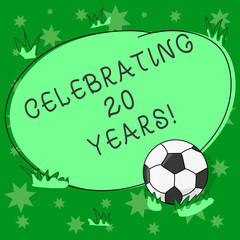 Writing note showing Celebrating 20 Years. Business photo showcasing Commemorating a special day being 20 years together Soccer Ball on the Grass and Blank Outlined Round Color Shape photo