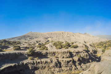 View on the Bromo volcano or Gunung Bromo on Indonesian in the Bromo Tengger Semeru National Park on the Java Island, Indonesia. One of the most famous volcanic objects in the world. Travel to