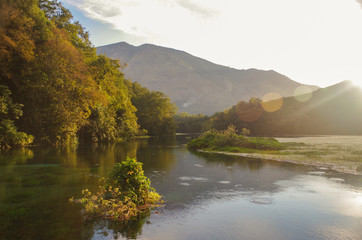 Autumn landscape in beams of the evening sun. Blue Eye Nature Monument. Nature and travel. Albania, Vlora County, near Saranda