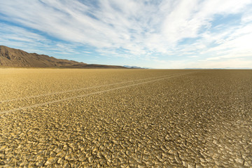 Naklejka premium Tire tracks running across the black rock desert playa