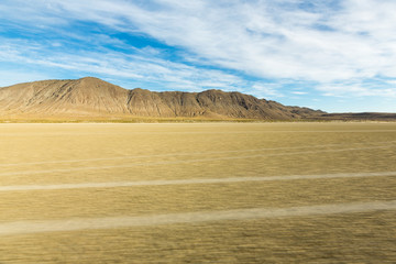 Tire tracks running across the black rock desert playa