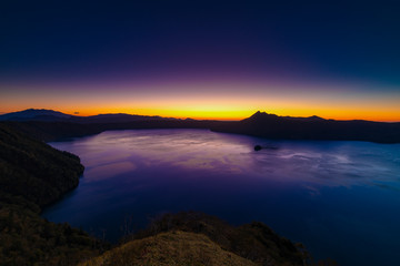sunrise over caldera lake in japan, hokkaido