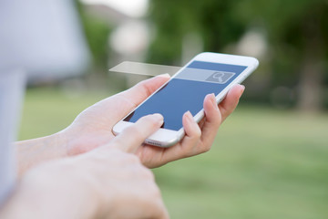Hands of woman with smartphone searching and big data concepts in the garden