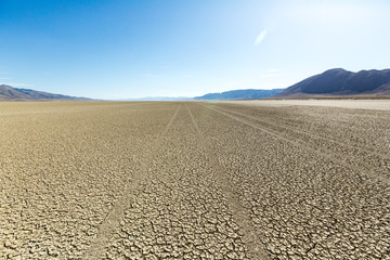 Naklejka premium Tire tracks running across the black rock desert playa