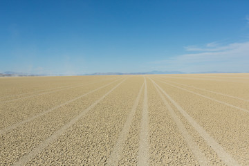 Tire tracks running across the black rock desert playa