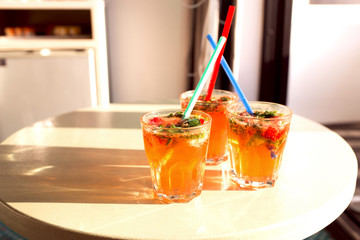 ?itrus crushed ice cold refreshing cocktail with mint. Glass of strawberry soda drink on light background. Selective focus, space for text.