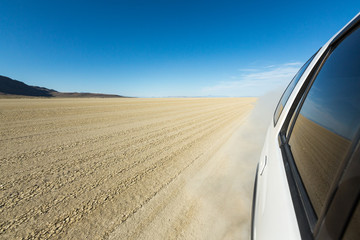 Car driving across the playa surface in the Black Rock desert