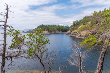 View over Inlet, ocean and island with boat and mountains in beautiful British Columbia. Canada.