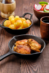 Roasted chicken thighs, fried potato and salad - rustic dinner