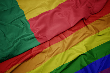 waving colorful gay rainbow flag and national flag of benin.