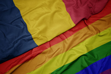 waving colorful gay rainbow flag and national flag of chad.