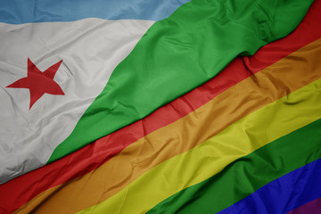 waving colorful gay rainbow flag and national flag of djibouti.