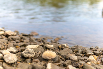 Rocks in a river with moss. Pebble stone background and texture.