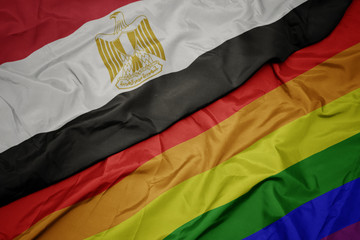 waving colorful gay rainbow flag and national flag of egypt.