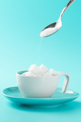 Minimalistic cup with sugar cubes and spoon