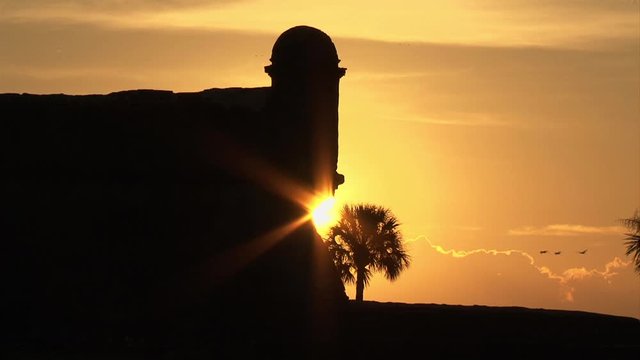 Saint Augustine-historic Spanish fort-Castillo de San Marcos-sunrise silhouette-sunburst-birds flying