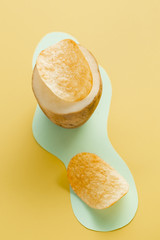 Half raw potato with crispy pieces of chips