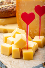 Love Dutch cheese concept, blocks of young and aged Gouda hard cheese