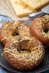 Tasty baked bagels with melted french emmental cheese