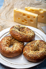Tasty baked bagels with melted french emmental cheese