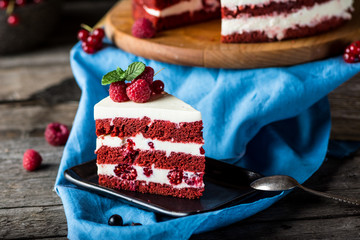 Red velvet cake on wood board. Slice of cake. Raspberry cake. Devil's cake. Wedding dessert. Birthday cake. Delicious dessert. Traditional american dessert