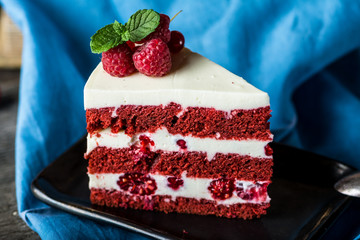 Red velvet cake on wood board. Slice of cake. Raspberry cake. Devil's cake. Wedding dessert. Birthday cake. Delicious dessert. Traditional american dessert