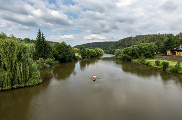 Fototapeta na wymiar panorama of river Sazava with green shores and sailing canoe downstream