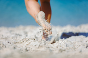 woman legs walking by sand beach summer time